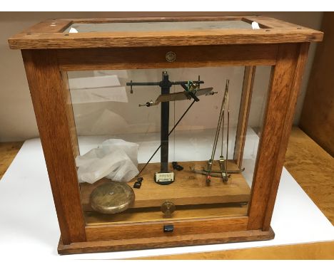 A set of oak cased scientific scales by Philip Harris Ltd of Birmingham, 46 cm x 25.5 cm x 43 cm high