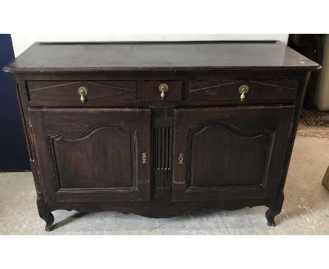 An 18th Century Flemish oak side cabinet, the plain top with moulded edge over two long and one short drawer and two fielded 