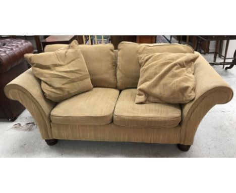 A modern two seat scroll arm sofa in gold chenille type striped upholstery, raised on turned mahogany feet, 187 cm long x 98 