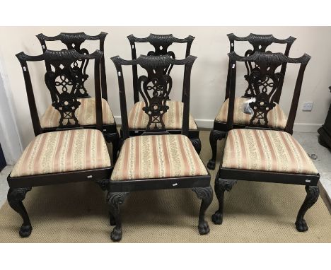 A set of six George iii dining chairs in the Chippendale taste, with carved back and splats, raised on upholstered seats to c