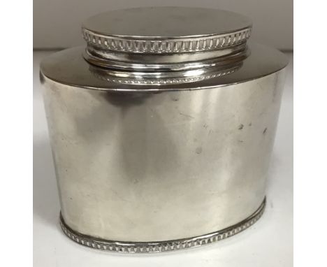 A George V silver tea caddy of oval form, the lid and base with egg and dart decoration (by Mappin & Webb, London 1924), 7.8 
