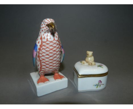 A Herend porcelain figure of a penguin, together with a Herend heart-shaped box with teddybear finial (2)