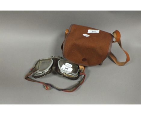 A set of early 20th Century aluminium and leatherette driving or flying goggles, together with a Kodak box camera with carry 