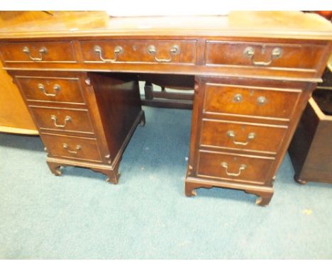 A crossbanded walnut pedestal desk with three frieze drawers and six pedestal drawers on bracket feet, 119cm wide, 58cm deep,