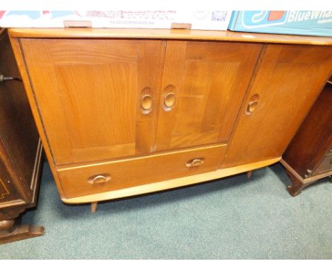 An Ercol elm sideboard with two cabinet doors above a drawer flanked by a single cabinet door, 114cm wide, 49cm deep, 81cm hi