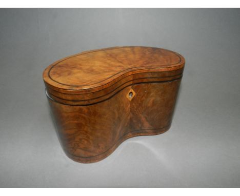 A 19th century walnut tea caddy of kidney form