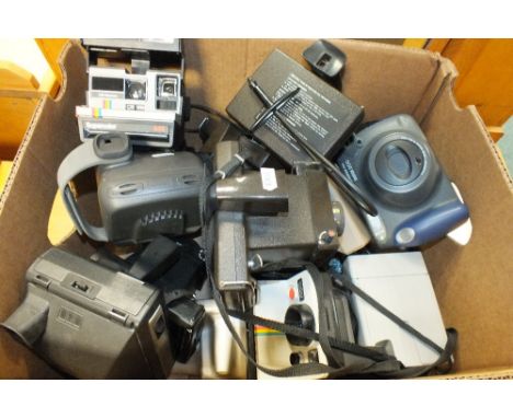 A box of Polaroid and other instant cameras, mostly by Polaroid also Fuji Film