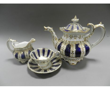 An early 19th century Coalport porcelain tea and coffee service decorated with dark blue and gilt stripes comprising six tea 