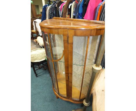 A 1930s walnut veneered shaped bowfront display cabinet on squat cabriole legs, 76cm wide, 33cm deep, 121cm high and a late V