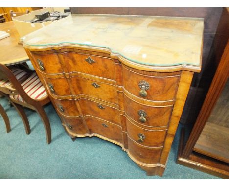 A Queen Anne style quarter veneered and crossbanded figured walnut shaped front chest of four long graduated cockbeaded drawe