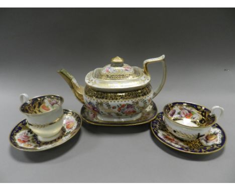 An early 19th century composite Coalport tea and coffee service decorated with panels of flowers and foliage within dark blue