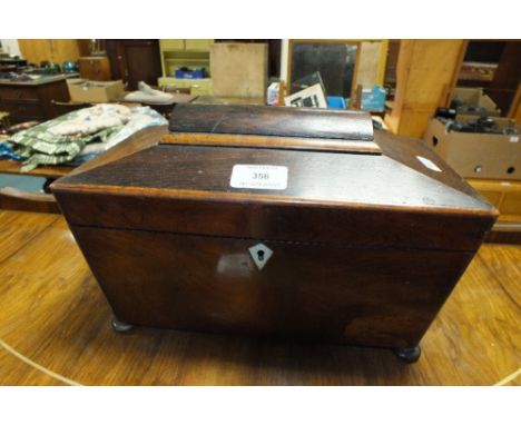 A William IV rosewood sarcophagus shape tea caddy with later moulded glass sugar bowl and two lidded compartments on bun feet