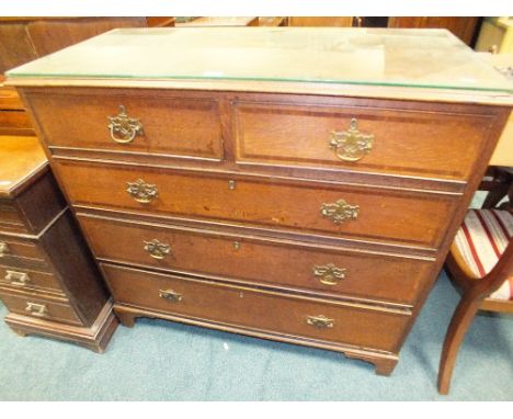 A George III oak and mahogany crossbanded chest of two short and three long graduated cockbeaded drawers on bracket feet, 110