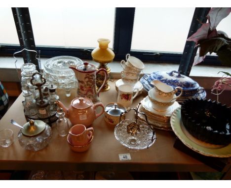 Shelf of mixed household items including ceramics and glass