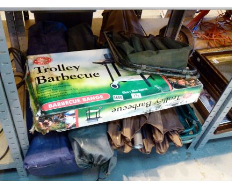 Shelf of folding garden chairs and a boxed trolley barbecue 