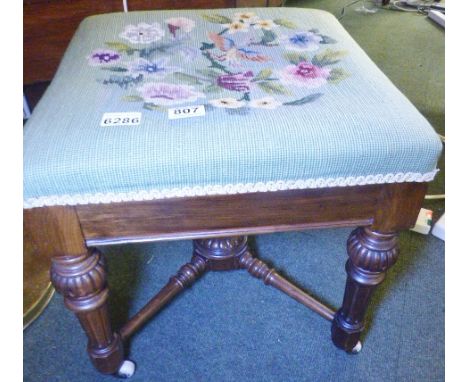 UPHOLSTERED STOOL. Upholstered vintage stool with cross stretcher on ceramic castors