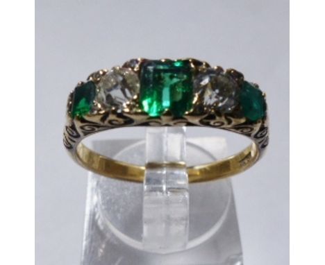 18CT GOLD EMERALD AND DIAMOND RING. 18ct yellow gold emerald and diamond dress ring, size R