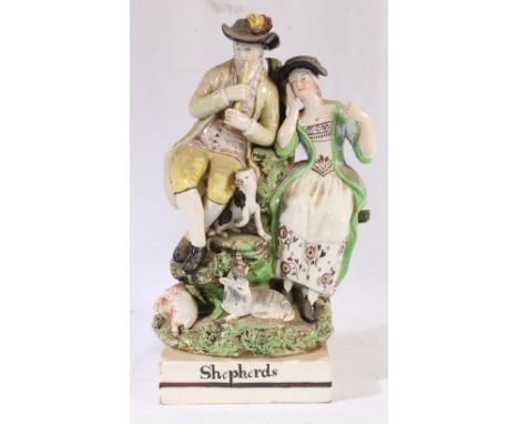 19th pearl ware figure titled 'Shepherds' modelled as male and female with sheep dog, goat and ewe, 28cm. CONDITION REPORT: N