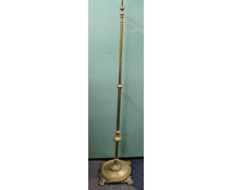 20th century telescopic brass standard lamp, raised on Rococo scroll feet, 200cm at tallest setting.