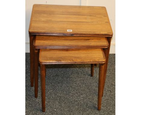 Nest of three Danish rosewood tables, the underside stamped 'Made In Denmark', largest 55cm long. CONDITION REPORT: Light sur