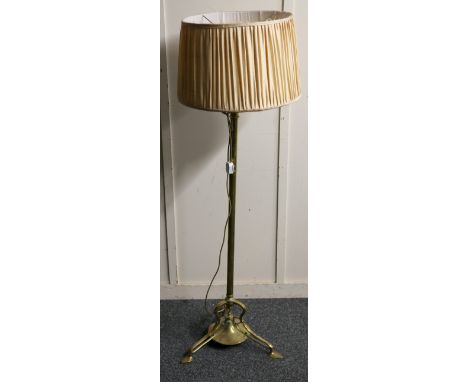 Art Nouveau style brass telescopic standard lamp raised on trefoil supports with shade, 170cm at tallest.