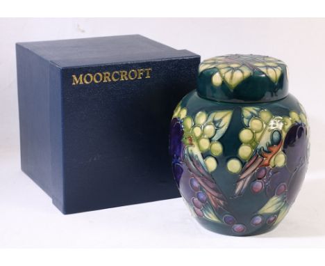Moorcroft ginger jar and cover of obovoid form with deep blue ground decorated with pomegranate, grapes and bird decoration, 