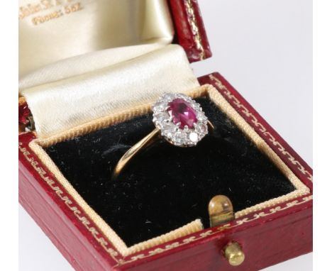 18ct gold diamond and ruby flowerhead ring, the stones in platinum setting, with central faceted ruby held in claw setting, s