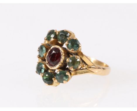 Japanese or Chinese yellow metal ring set with eight blue green faceted stones, encircling and oval faceted ruby or garnet, t