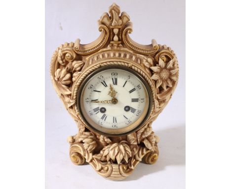 Late Victorian Royal Worcester clock with scrolling foliate decoration, circular face, Roman and Arabic numerals, striking be