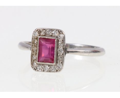 Art Deco style platinum ring set with central baguette cut ruby encircled by sixteen diamonds. size R. 3.9g   CONDITION REPOR