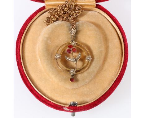 9ct gold ruby and seed pearl open work pendant on gold plated neck chain, 5.8g gross.