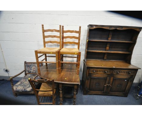 AN OAK DRESSER, with a two tier plate rack, base with two drawers above two cupboard doors with carved rose to front, length 