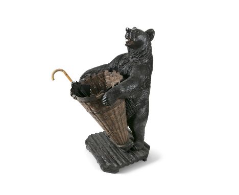 A LARGE SWISS 'BLACK FOREST' CARVED LINDEN WOOD BEAR HALL/UMBRELLA STAND, 19th Century, the standing bear holding a woven bas