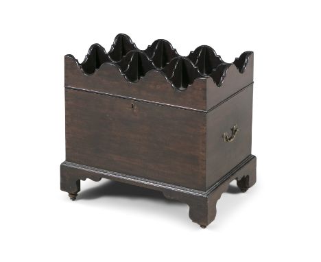 AN IRISH GEORGE III MAHOGANY CELLARETTE, the hinged cover formed as a cutlery tray with castellated rim and quatrefoil divisi