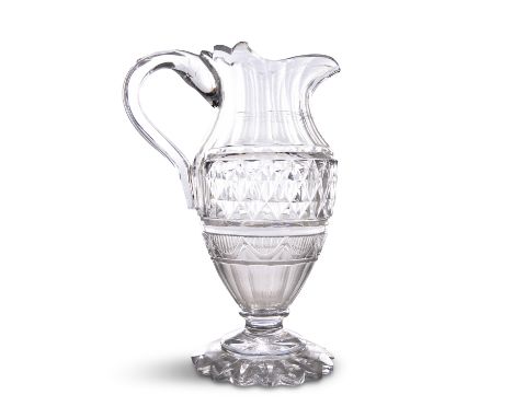 A HANDSOME CUT-GLASS CLARET JUG, probably Irish, c. 1800, the facetted neck above a deep bowl of flat-cut diamonds, and a sma