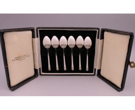 A boxed set of silver gilt white enamel coffee spoons, Birmingham 1949. 