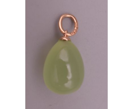 A 14 ct gold mounted jade egg form pendant. 2 cm high.