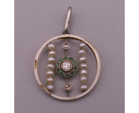 An Edwardian emerald, pearl, enamel and diamond openwork pendant. 2 cm high.