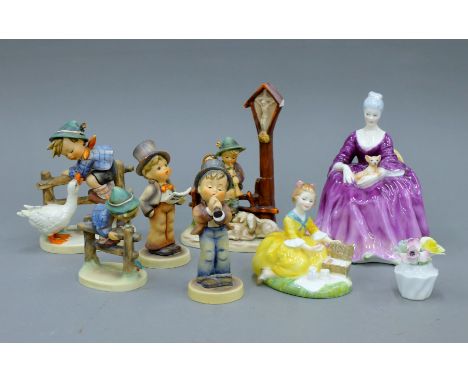 Two Doulton figurines and five Hummel figurines.