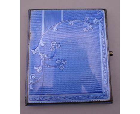 A silver and enamel cigarette case. 7 cm wide.
