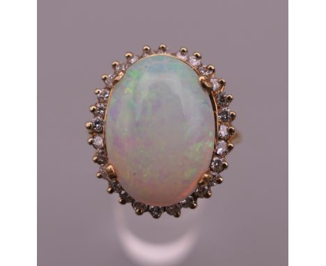 An unmarked gold opal and diamond ring. Ring size Q.  6.8 grammes total weight.