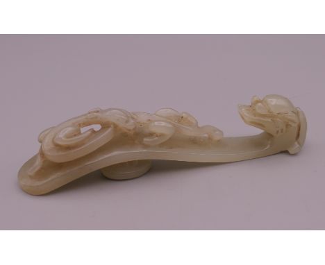 A Chinese jade dog of fo belt hook. 9 cm long.