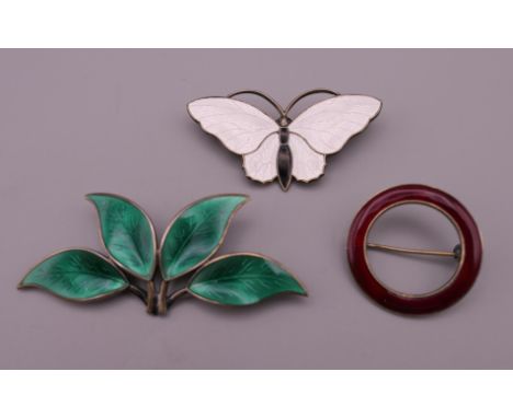 Three Norwegian silver and enamel brooches. The largest 6.5 cm long.