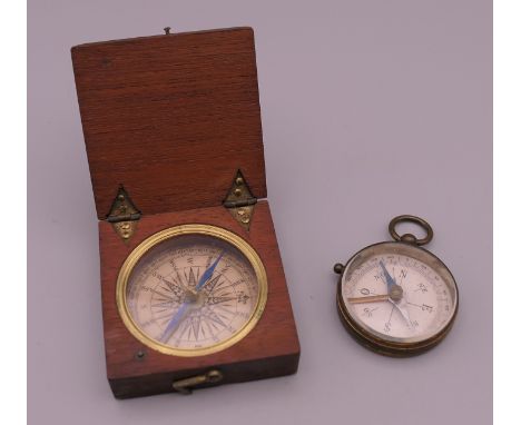 A Victorian compass in small wooden travelling case and a small Victorian gilded brass compass. The former 5 cm wide.