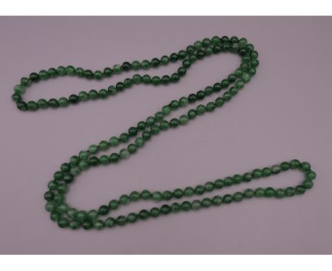 A string of jade beads. 132 cm long.