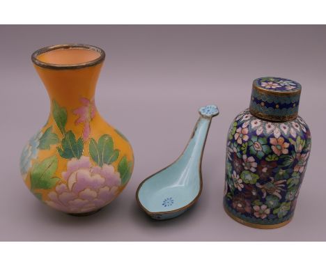 A Chinese plique a jour vase, a cloisonne jar and cover and a Canton enamel spoon. The former 10 cm high.