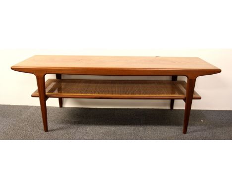 A 1970's teak coffee table with cane shelf, L. 137cm.