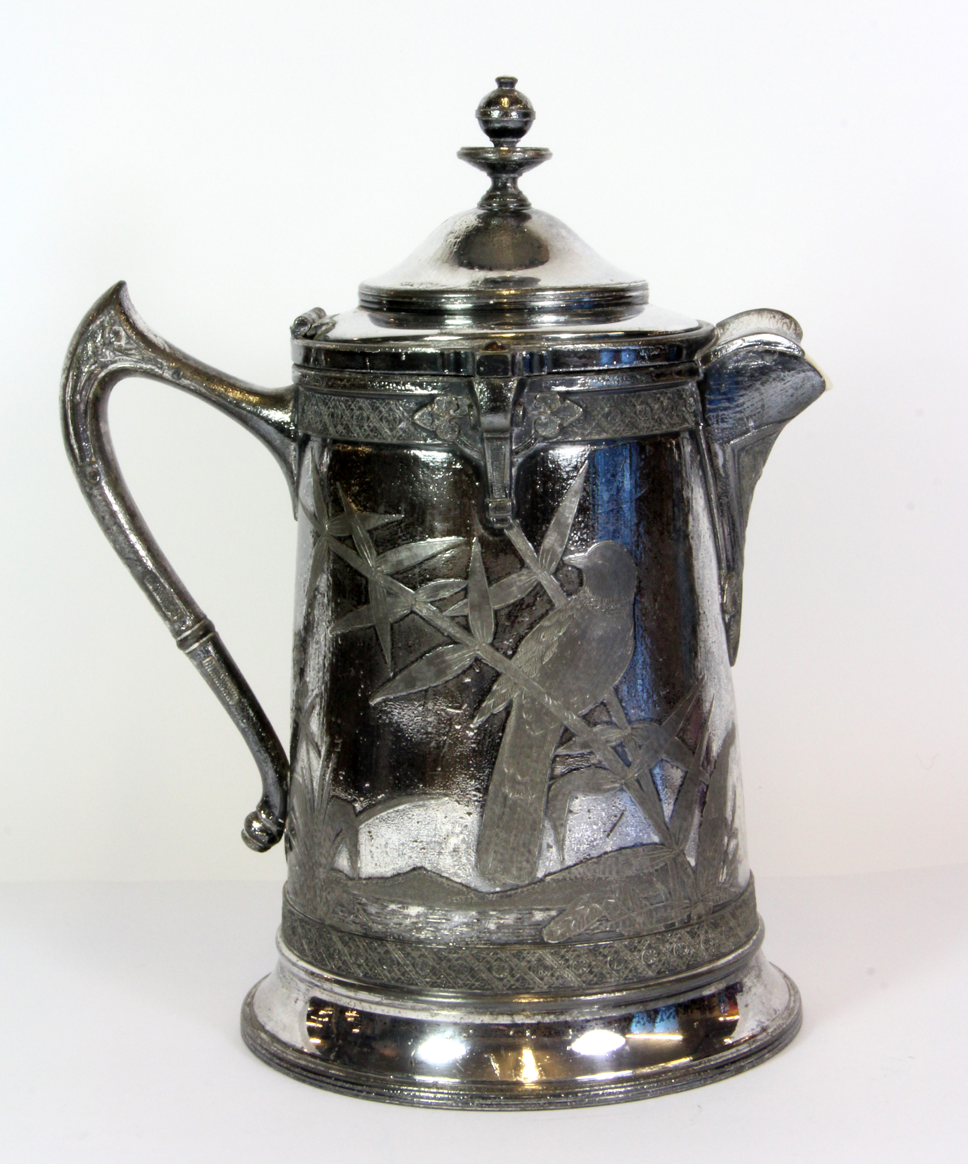 An interesting 19th century ceramic lined silver plated jug, H. 27cm.