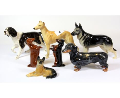 A collection of Beswick, Royal Doulton and Goebels ceramic dog figures.