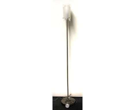 A contemporary stainless steel standard lamp.